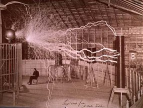 Tesla seated by coil ~ surrounded by millions of volts of electricity