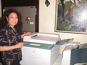 Sue-On using the ERB Inc. photocopier while NC Wyeth's Tarzan looks on