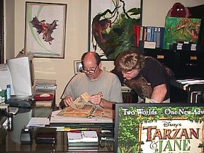 Danton and Bill Hillman examining Ed's clippings scrapbook