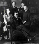 Burroughs family posing beside the grand piano