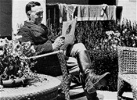 Ed reading on the patio with new hairdo