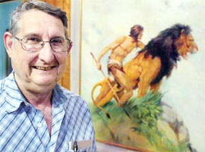 S.Bradleigh Vinson stands by one of artist John Allen St. John’s paintings that he has in his house.