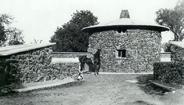 Charmian Kittredge London on horseback inside the Pig Palace