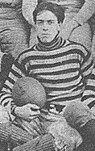 Quarterback Ed Burroughs posing with his football team mates