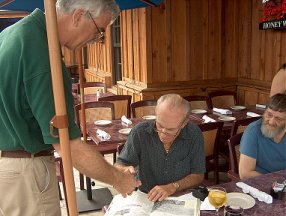 Joog passing around Jim Thompson's special autograph book