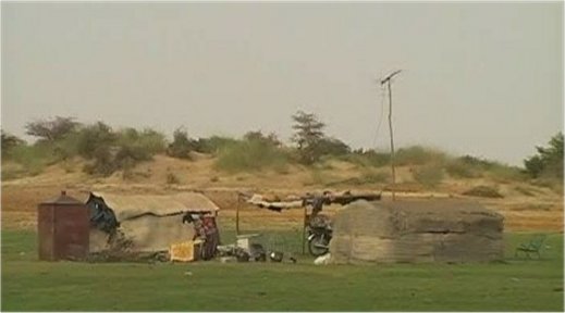 Grass Huts (with TV aerial and motorcycle)