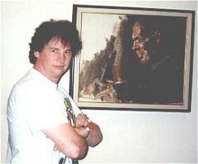 Geoff stands beside a portrait of Burroughs in the Tarzana office