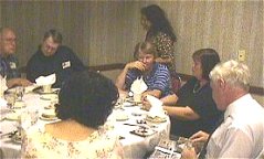 Dejah visiting Tarak and Predator's table at banquet