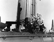 Sailors manning the ship's forward quad torpedo tubes