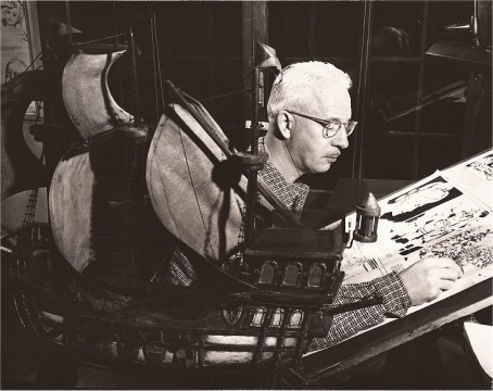 At work with ship model in foreground.